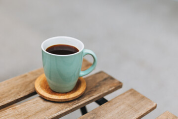 Cup of black coffee on a table in a street cafe.