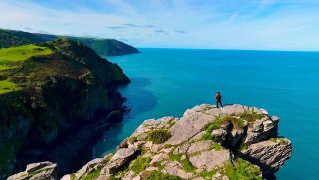 Photographer shooting the Valley of Rocks,  a dry valley that runs parallel to the coast in north Devon in Exmoor national park in England, UK