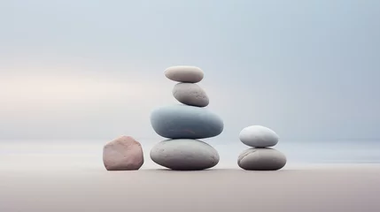 Foto op Canvas Pebble cairns, stacks of smooth pebbles on the seaside. Stone stacks on the sand beach near a calm misty ocean. Beautiful, quiet seascape. Peaceful meditative mood. Copy space. © Studio Light & Shade