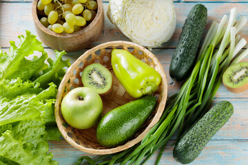 Fresh Green Vegetables and Fruits on Weathered Painted Boards, Top View