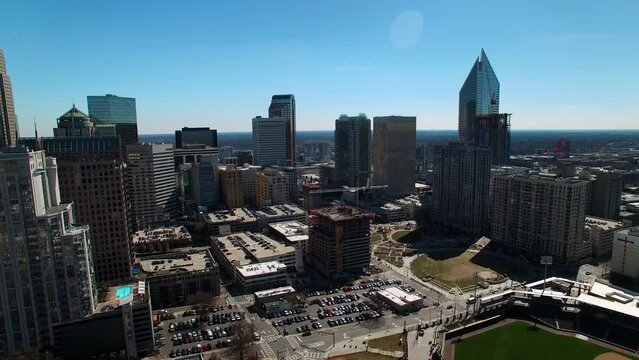 Aerial Panning Shot Of Parking Lot In Modern Financial District Against Clear Sky On Sunny Day - Charlotte, North Carolina