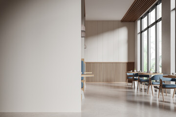 Beige restaurant interior with chairs and tables in row, mock up wall