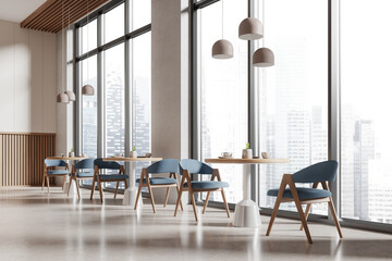 Stylish cafeteria interior with seats and tables in row near panoramic window