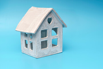 Ceramic toy house on blue background