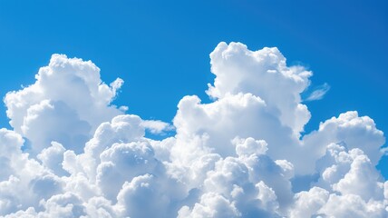 Fluffy white clouds against a bright blue sky