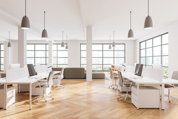 Modern coworking interior work table and lounge zone near panoramic window