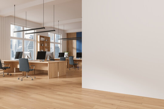 Stylish office interior with workspace and window. Mock up empty wall