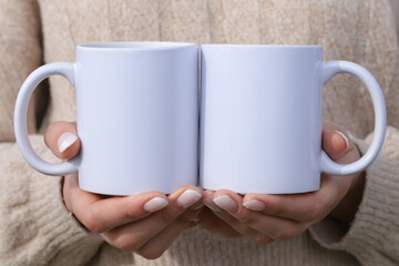 hands holding  two cups
