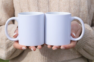 Girl holding mugs in hand