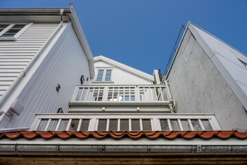 Looking up balconies of a wooden apartment building.