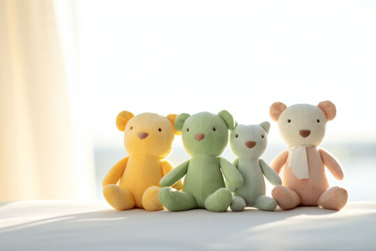 Pastel-colored orange and green teddy bears seated against a sunny window create an image of gentle warmth and comforting softness.