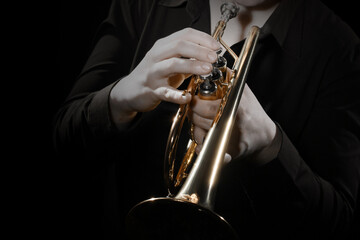 Trumpet player playing jazz music instrument. Trumpeter hands closeup