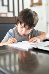 boy studying in front of a computer