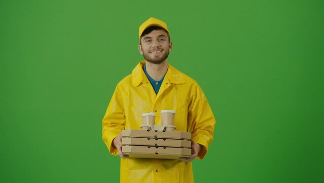 Green Screen Food Delivery Person Using a Smartphone to Searching for Fast Food Delivery Addresses. Food Delivery Person in Yellow Uniform Using Smartphone to Check Order. Fast delivery