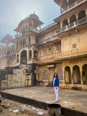 Fototapeta na wymiar Galta Ji, India - January 4, 2024: A female tourist near Galta Mandir palace