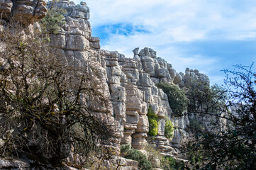 Fototapeta na wymiar Hiking the Torcal de Antequerra National Park, limestone rock formations and known for unusual karst landforms in Andalusia, Malaga, Spain.