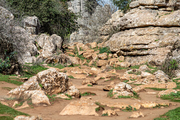 Hiking the Torcal de Antequerra National Park, limestone rock formations and known for unusual karst landforms in Andalusia, Malaga, Spain.