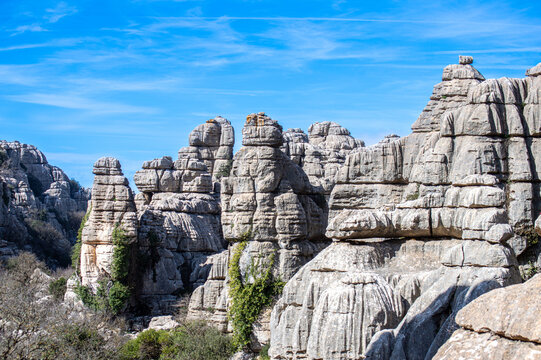 Hiking the Torcal de Antequerra National Park, limestone rock formations and known for unusual karst landforms in Andalusia, Malaga, Spain.