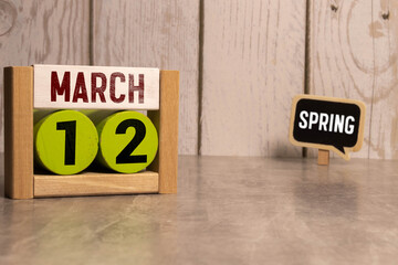 Vintage photo, March 12th. Date of 12 March on wooden cube calendar, copy space for text on board.