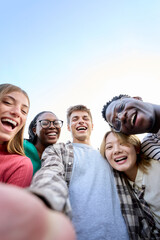 Vertical selfie Portrait large group multiracial friends posing smiling and looking to camera....
