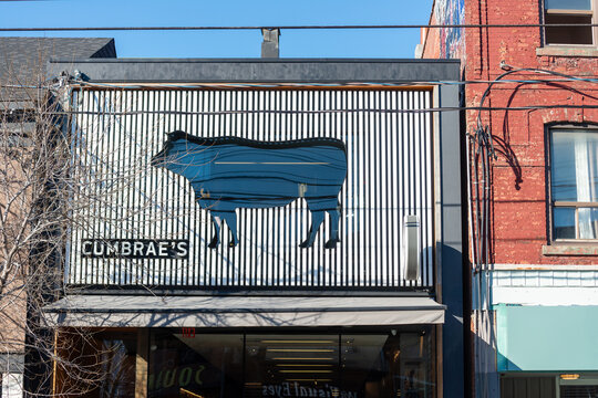 exterior building facade and creative sign at Cumbrae's, a butcher shop, located at 714 Queen Street West in Toronto, Canada