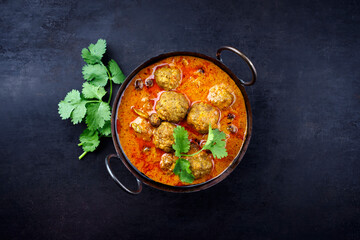 Traditional spicy Indian meat balls curry Rogan Josh with ground beef and spice served as top view...