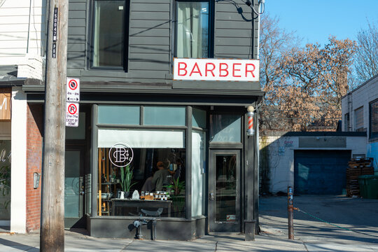 exterior building facade windows entrance sign and barber pole of Barber Shop located at 89 Ossington Avenue in Toronto, Canada
