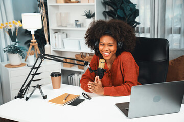 Host channel of beautiful African woman talking in online broadcast teaching marketing influencer, with listeners in broadcast or online. Concept of anywhere at work place. Tastemaker. - obrazy, fototapety, plakaty