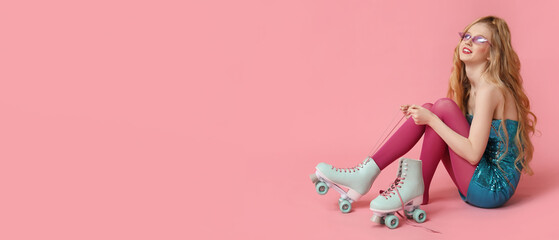 Obraz na płótnie Canvas Beautiful young woman tying vintage roller skates on pink background with space for text