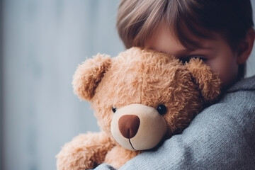 A touching scene of a girl hugging her teddy bear, showing adorable shyness. - obrazy, fototapety, plakaty