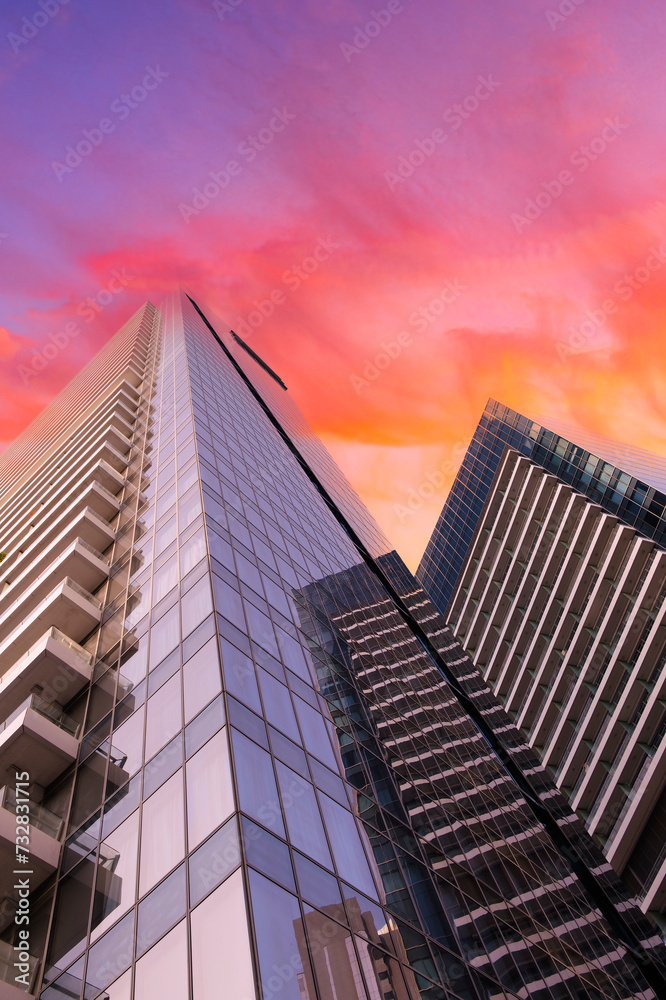 Aufkleber skyscraper from bottom to top against red sunset sky, business developer concept background