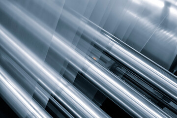 Automatic polyethylene plastic bag production machine with lighting effect. Close-up of the roller of the plastic bag production machine in the light blue scene. product packaging concept