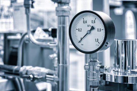 Industrial  concept. equipment of the boiler-house, - valves, tubes, pressure gauges, thermometer. Close up of manometer, pipe, flow meter, water pumps and valves of heating system in a boiler room.