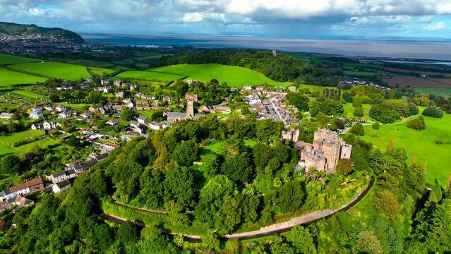 Aerial view of Dunster Castle in the village of Dunster, Somerset, England, UK