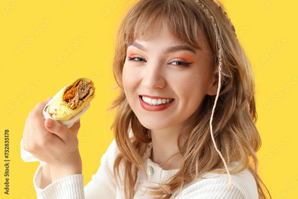 Canvas Prints Young woman with tasty sandwich wrap on yellow background, closeup