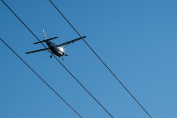 an airplane looks flying along lines