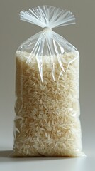 A transparent plastic bag contains rice grains, useful in preserving food. Plastic bag of rice representing sustenance and nutrition. Little rice or grains concept.