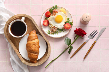 Composition with tasty fried egg in plate, croissant and cup of coffee on light tile background