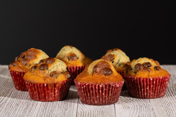 Close up of just baked blueberry muffins on rustic table. Selective focus on middle muffins.