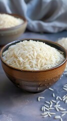A bowl full of cooked rice exudes a comforting aroma and invites culinary delight. Soft, steaming rice grains reflect the simplicity and essence of traditional cuisine.