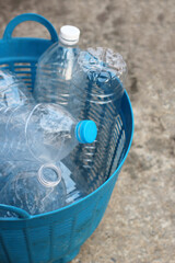 Empty drink bottles in blue plastic basket