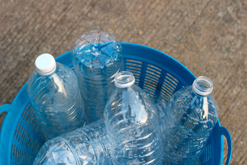 Empty drink bottles in blue plastic basket