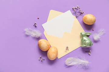 Blank card with Easter eggs, feathers and beautiful gypsophila flowers on lilac background