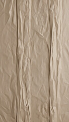 Rough and wrinkled abstract vertical background texture with folds and creases in brown vintage paper