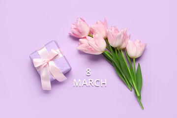 Text 8 MARCH with gift box and beautiful tulips on lilac background. International Women's Day