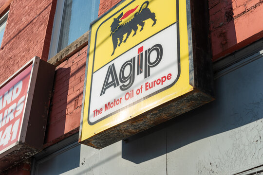 exterior box sign featuring Agip "The Motor Oil of Europe" outside Autosonic Service Station, an auto repair shop, located at 1244 Dundas Street West in Toronto, Canada