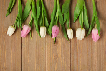 Beautiful tulips on wooden background. International Women's Day