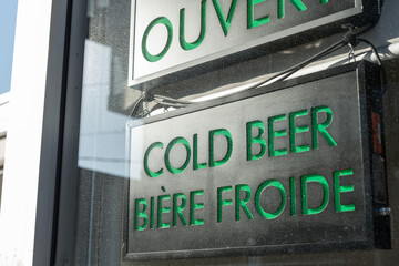 english and french sign advertising cold beer in a shop window