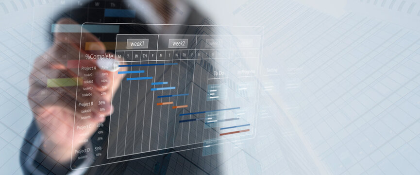 Business Project Management System. Project manager updating tasks and milestones progress planning with Gantt chart scheduling interface on a virtual screen