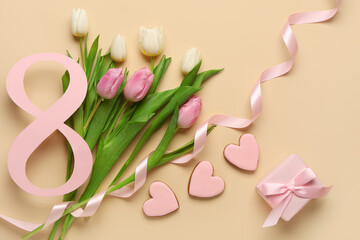 Figure 8 made of paper with tulip flowers, cookies and gift box on beige background. International Women's Day celebration